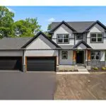 Light gray two-story house with three bays