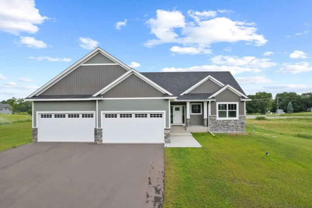 Modern ranch home with spacious driveway and lawn