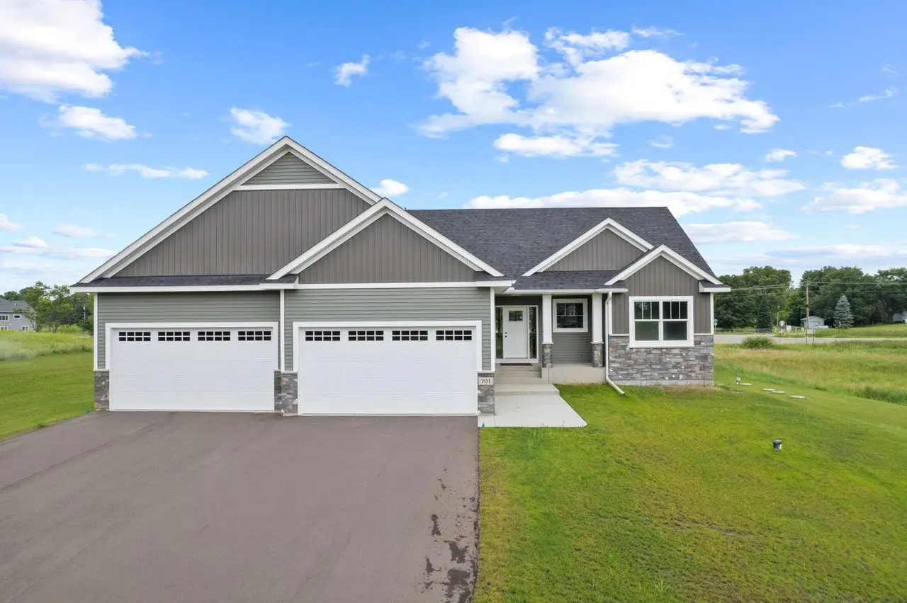 Modern ranch home with spacious driveway and lawn