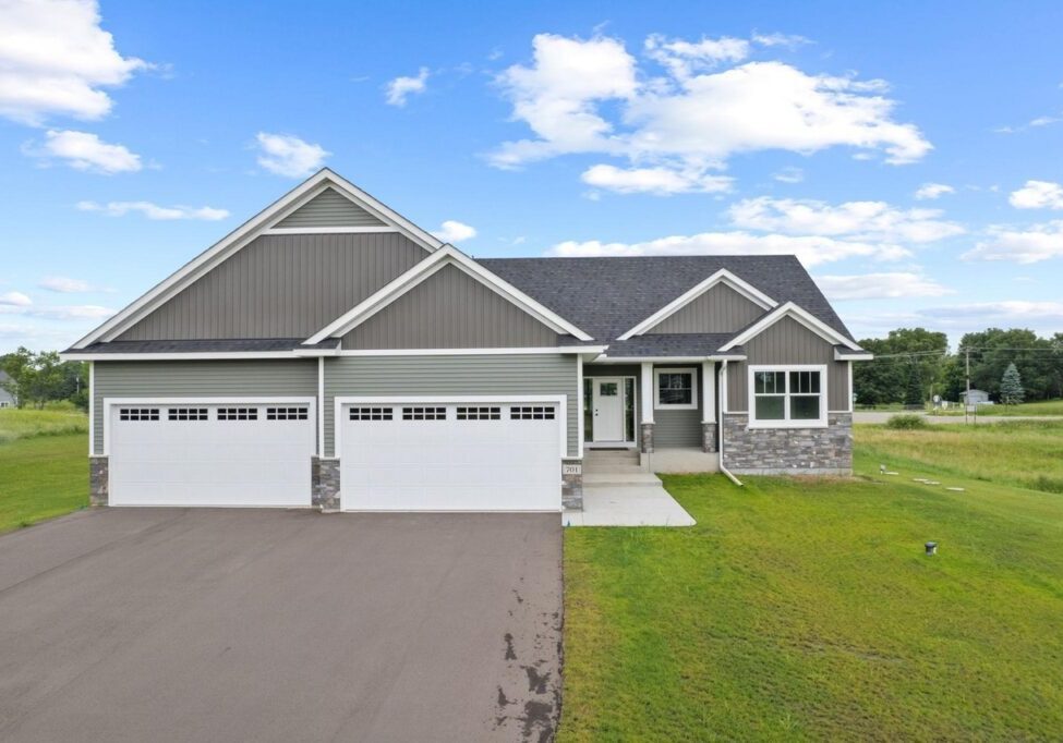 Modern ranch home with spacious driveway and lawn